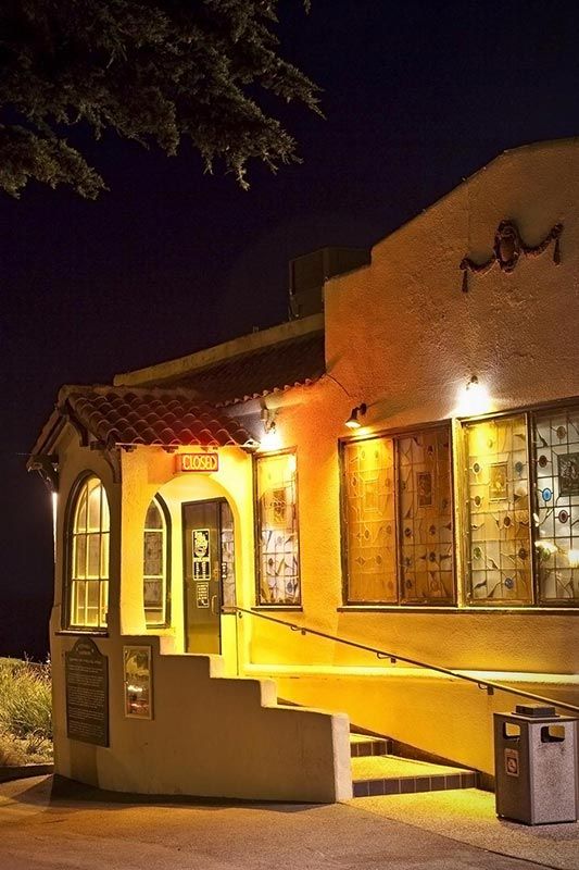 Moss Beach Distillery restaurant entrance at night by Salty Raven Studio